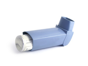 Blue asthma inhaler isolated on white background